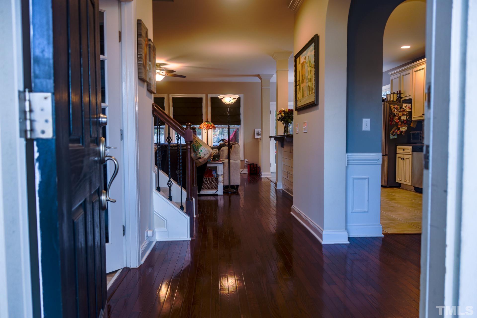 10100 Darling Street Raleigh, NC 27613 - Photo 15 of 24 a view of a hallway with wooden floor