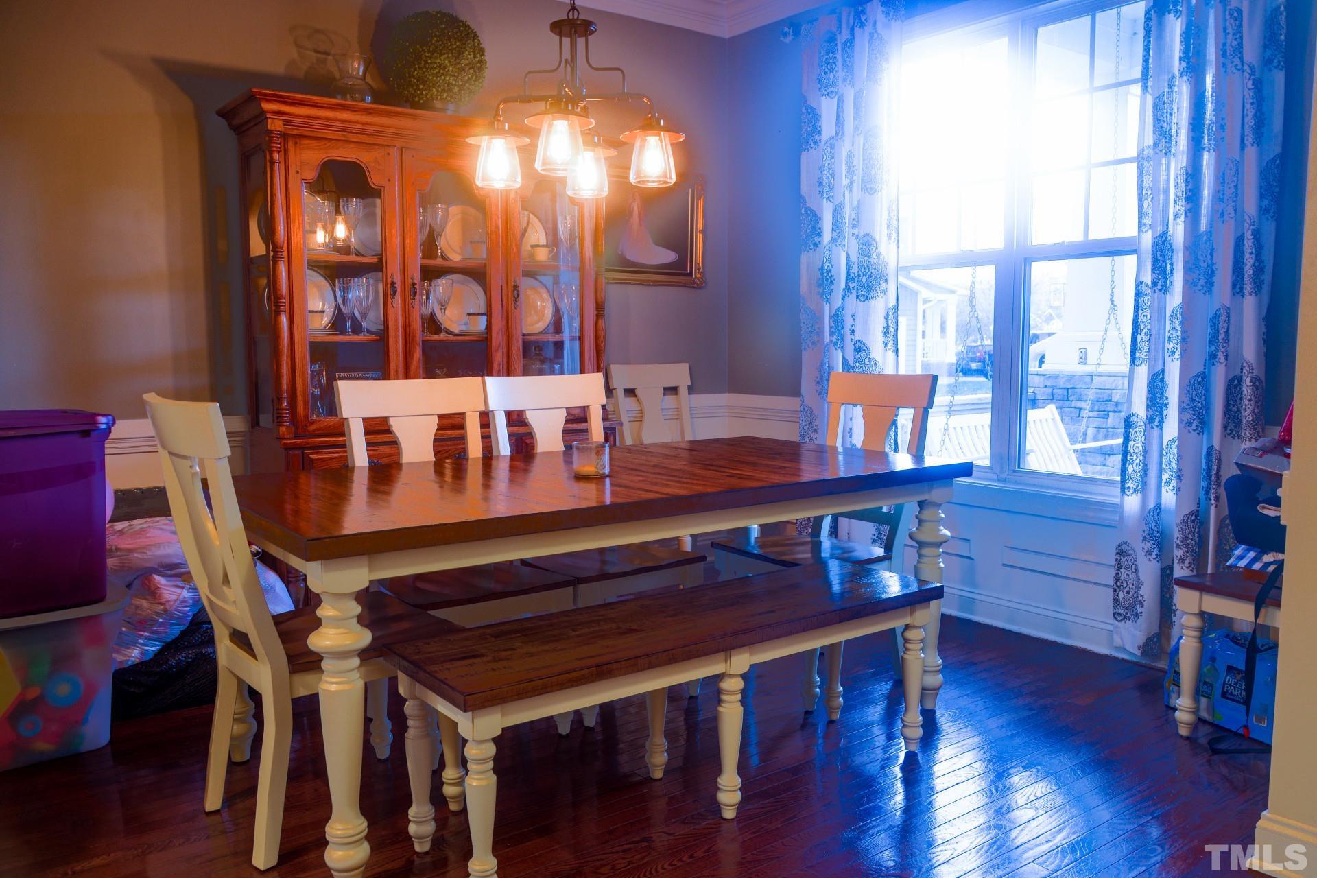 10100 Darling Street Raleigh, NC 27613 - Photo 16 of 24 a view of a dining room with furniture window and wooden floor