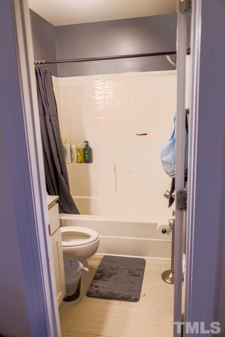 10100 Darling Street Raleigh, NC 27613 - Photo 21 of 24 a bathroom with a shower a toilet and a shower