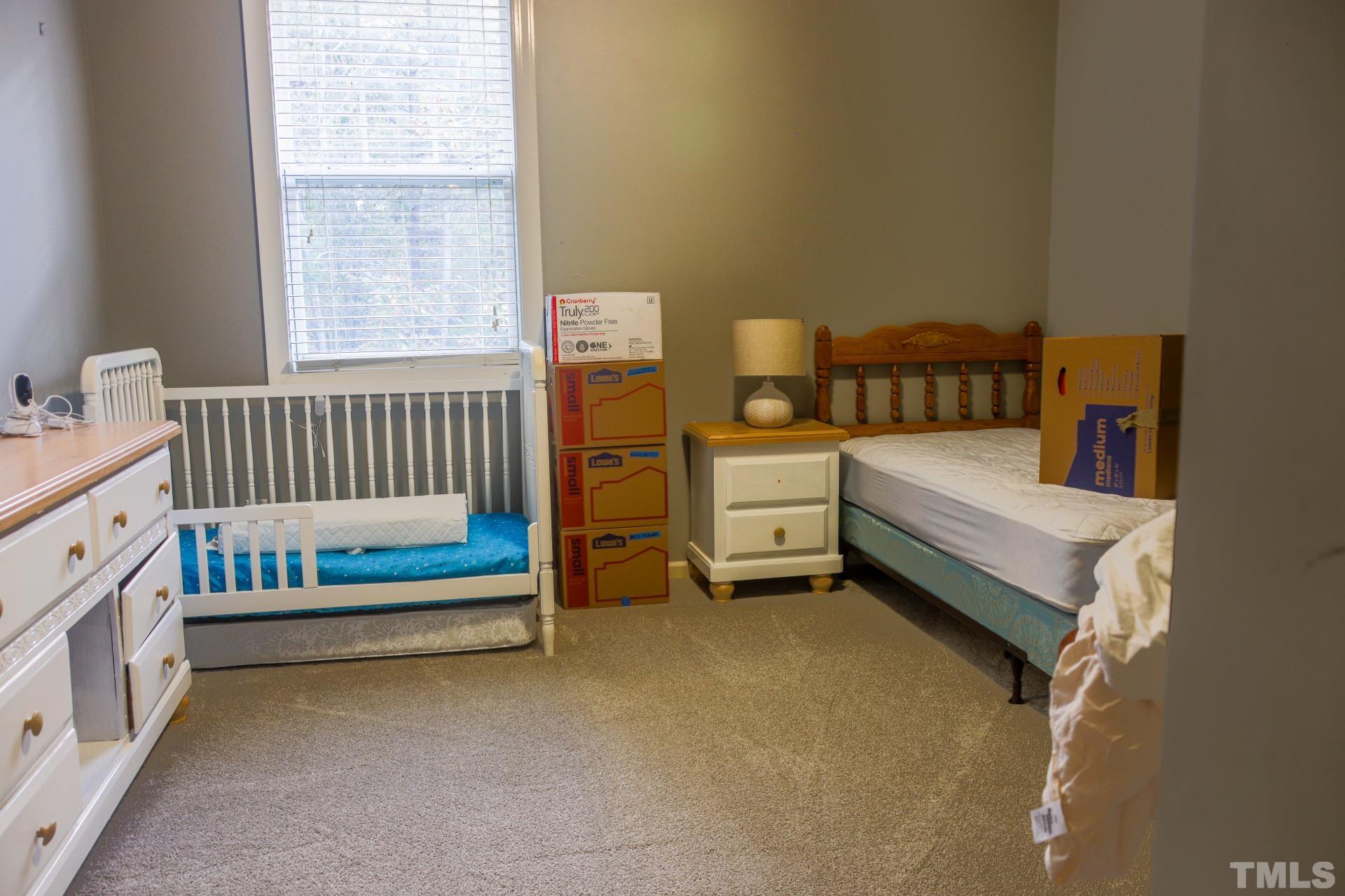 10100 Darling Street Raleigh, NC 27613 - Photo 22 of 24 a bedroom with bed and a window