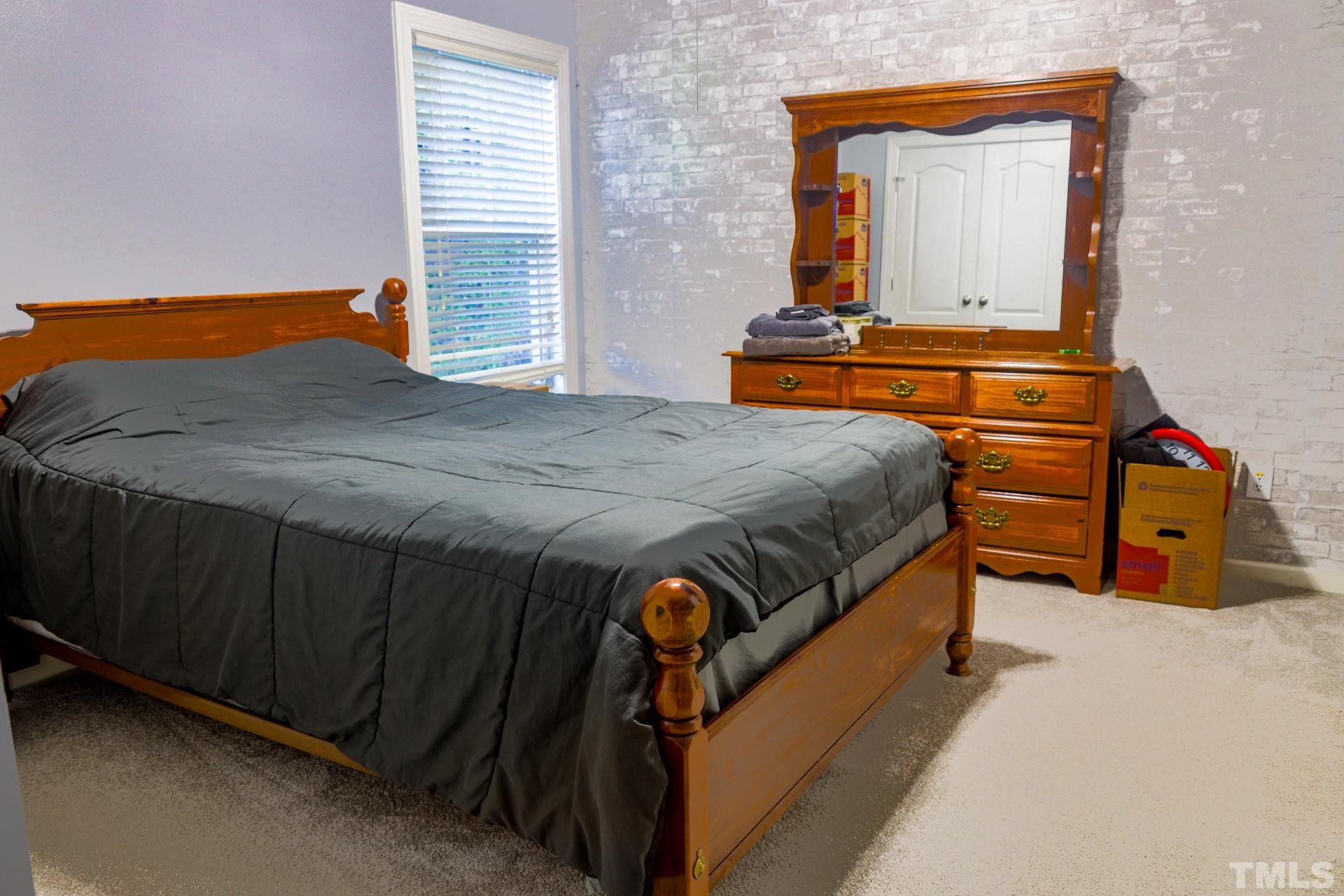 10100 Darling Street Raleigh, NC 27613 - Photo 23 of 24 a bedroom with a bed and a dresser