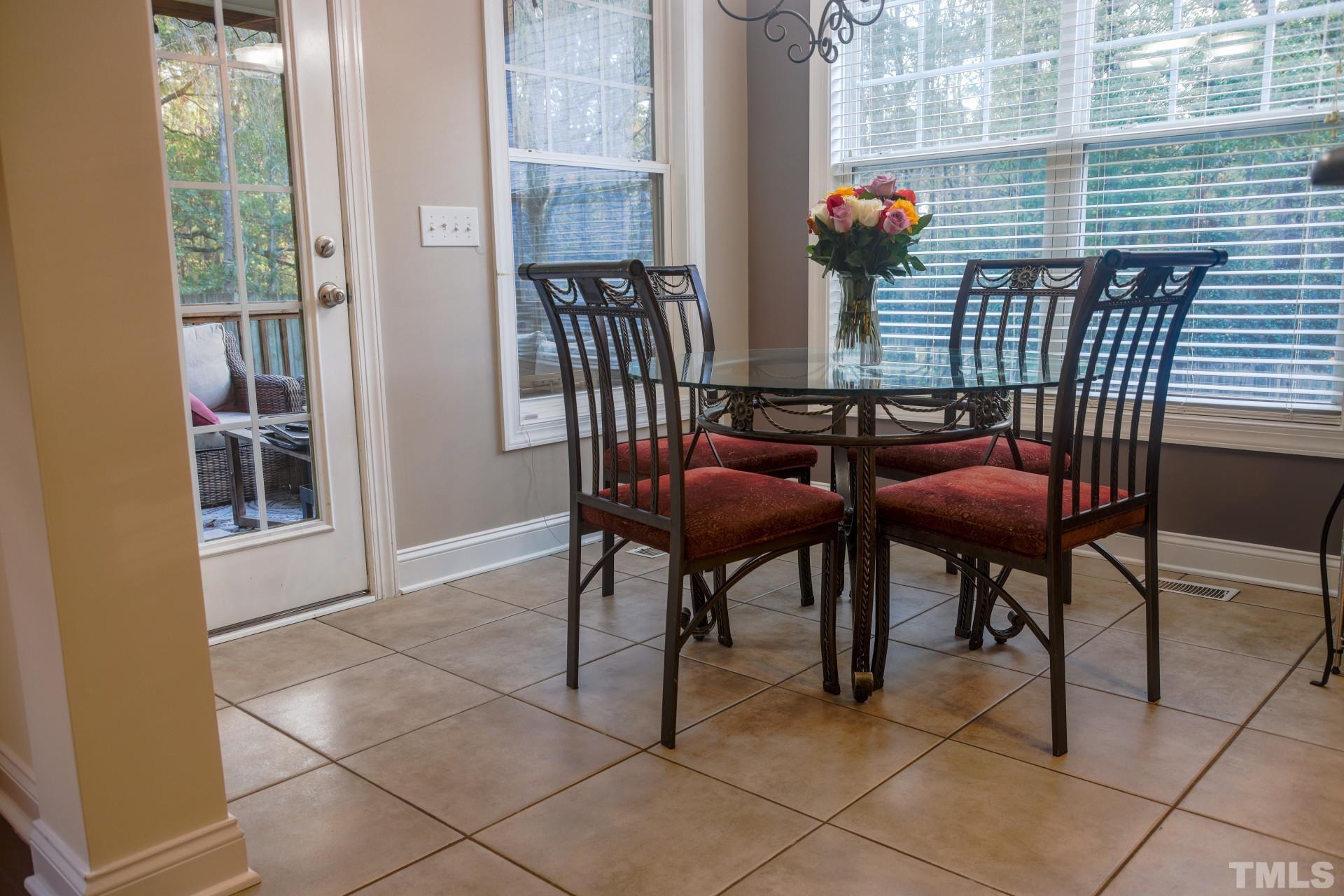 10100 Darling Street Raleigh, NC 27613 - Photo 8 of 24 a view of a dining room with furniture and wooden floor