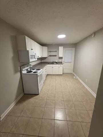 a kitchen with a stove a sink and a refrigerator