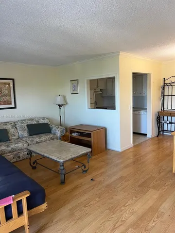 a bedroom with furniture and a wooden floor