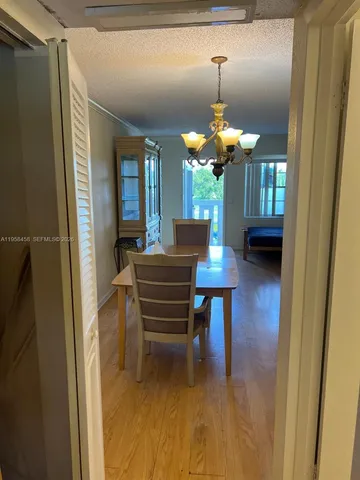 a dining room with furniture and a chandelier