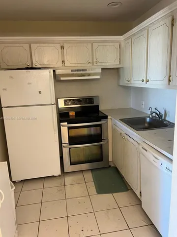 a kitchen with cabinets and appliances