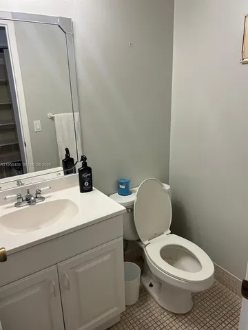 a bathroom with a toilet a sink and mirror