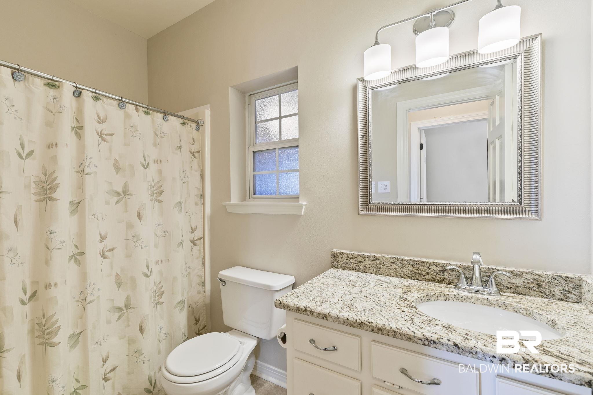 9631 Bay Meadows Avenue Fairhope, AL 36532 - Photo 26 of 49 Bathroom featuring curtained shower, vanity, and toilet