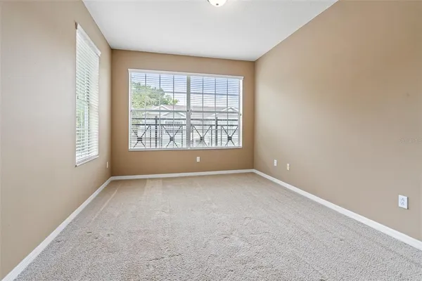 an empty room with windows and closet