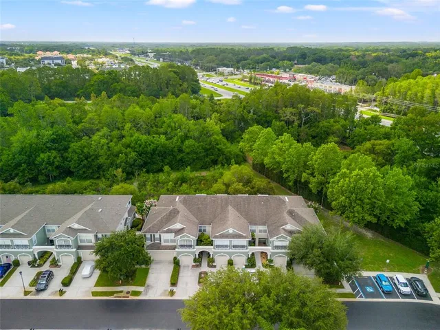 an aerial view of a house with swimming pool and garden