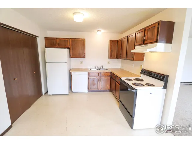 a kitchen with stainless steel appliances a stove a refrigerator a sink and dishwasher