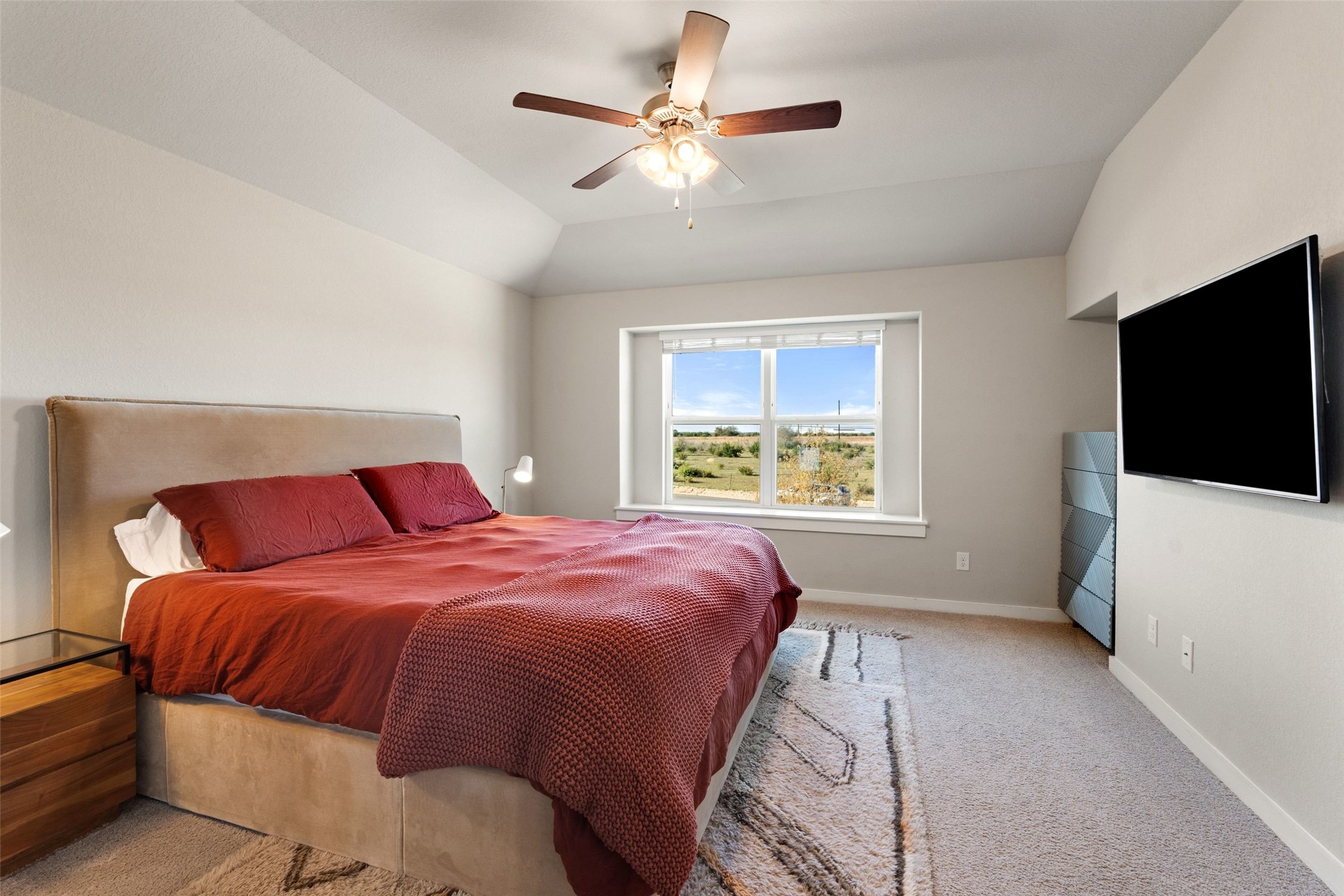 2251 Rocoso Trail Leander, TX 78641 - Photo 11 of 24 a bedroom with a large bed and a flat screen tv