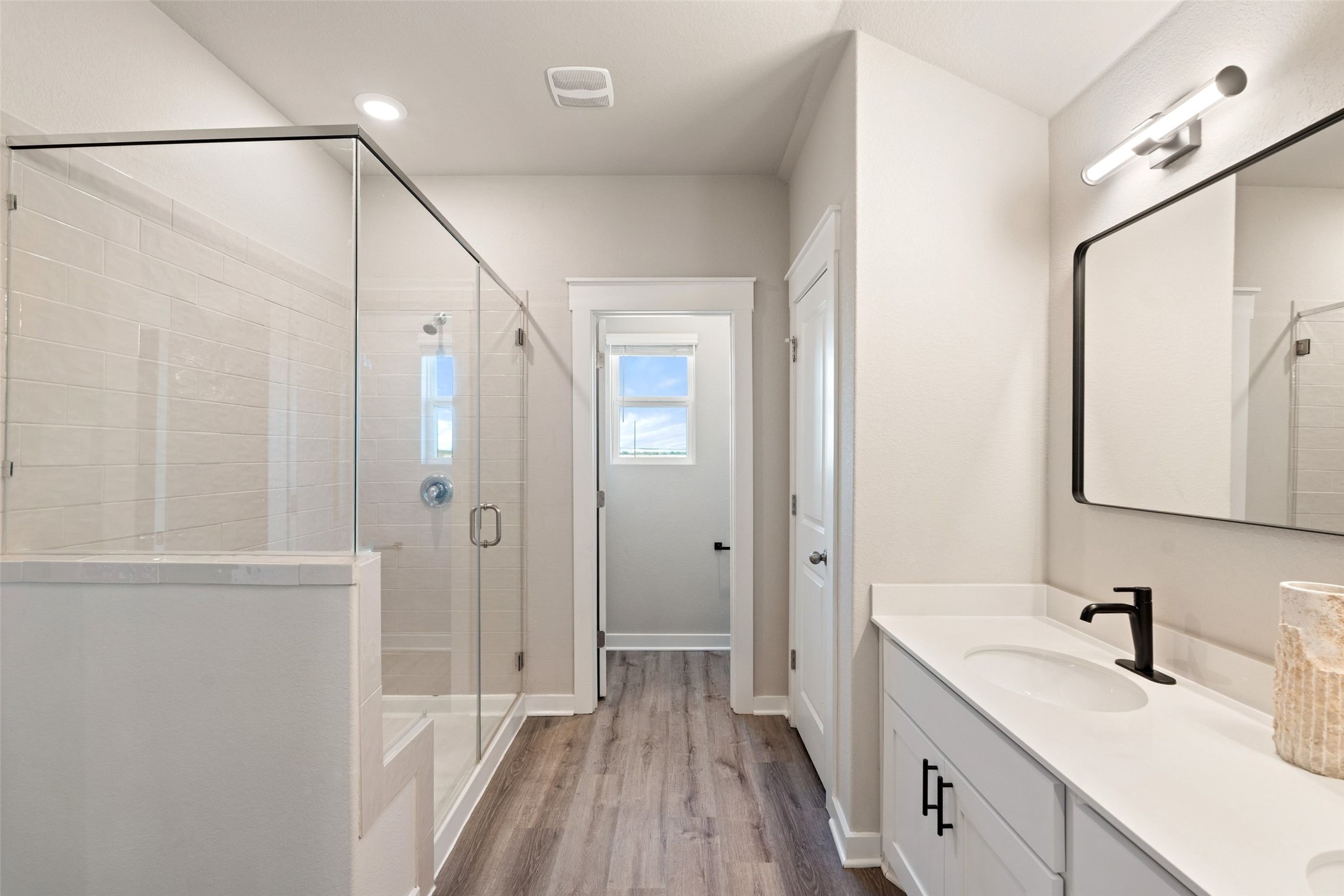 2251 Rocoso Trail Leander, TX 78641 - Photo 13 of 24 a bathroom with a double vanity sink a mirror and a shower