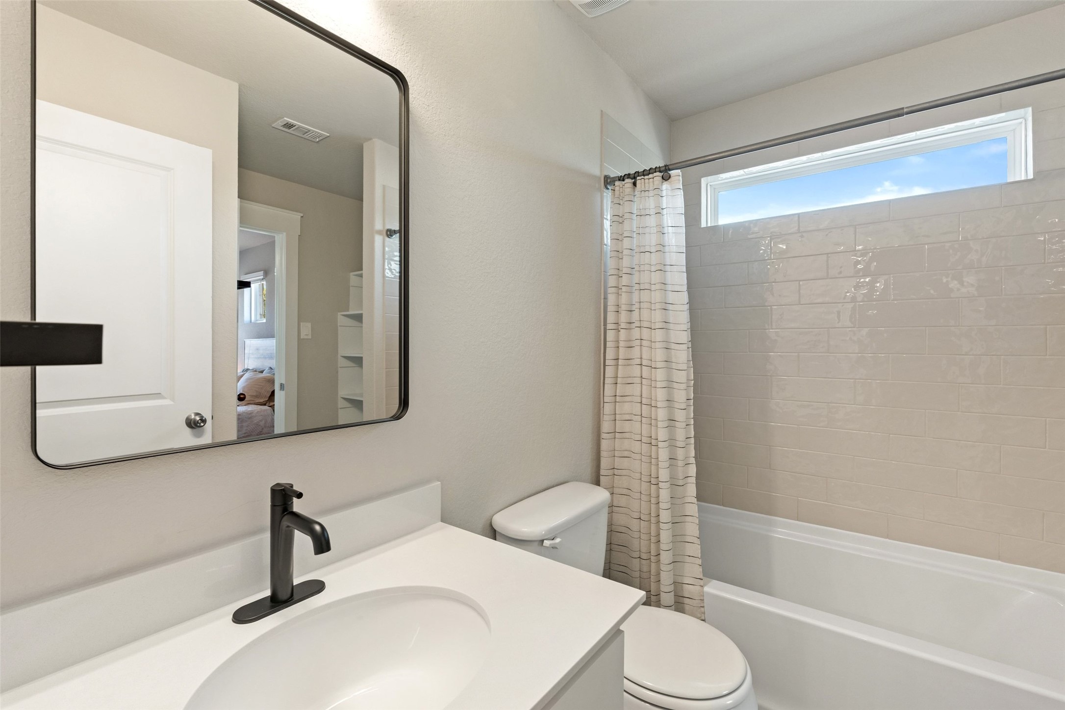 2251 Rocoso Trail Leander, TX 78641 - Photo 18 of 24 a bathroom with a sink toilet and shower