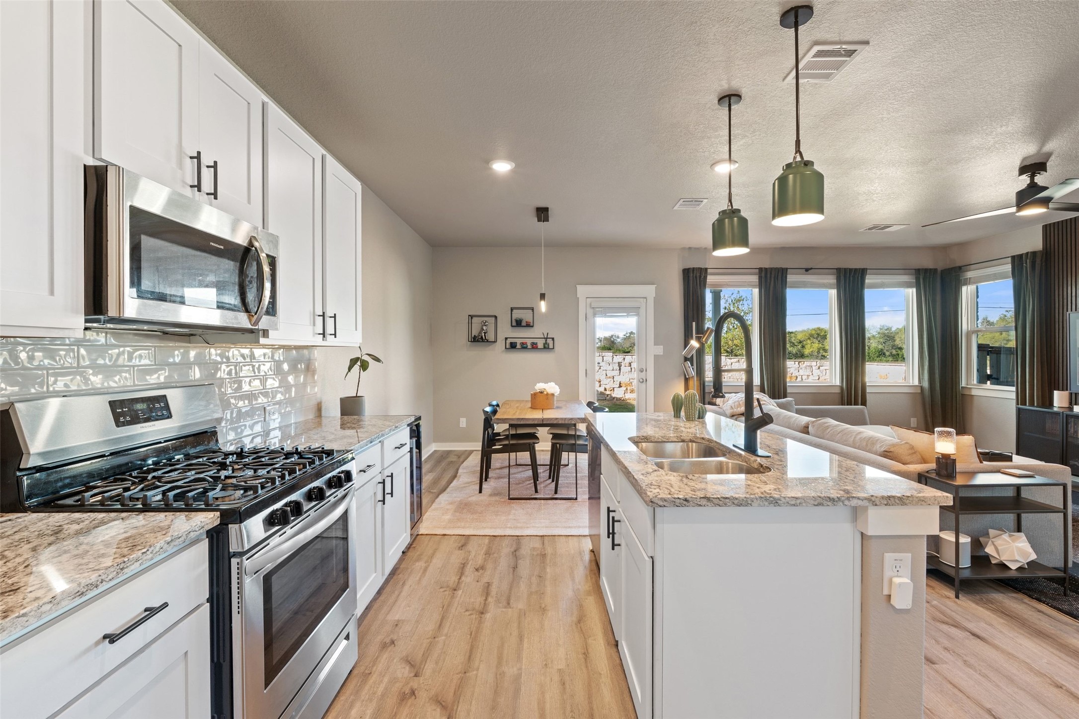2251 Rocoso Trail Leander, TX 78641 - Photo 8 of 24 a kitchen with sink stove and cabinets