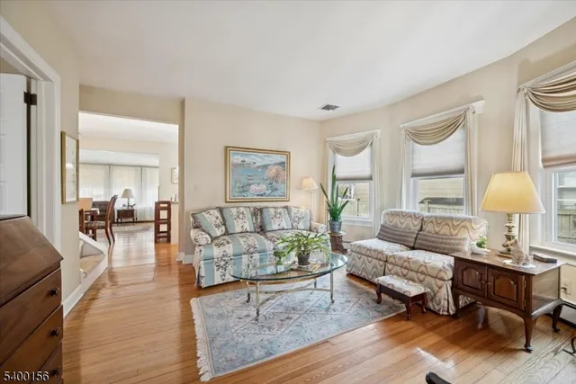 a view of a workspace with furniture and wooden floor