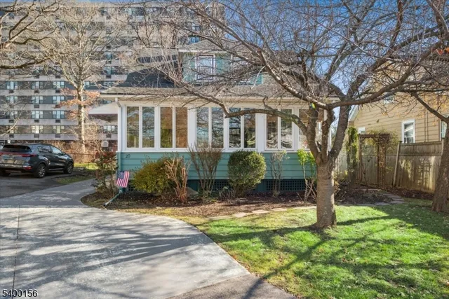 a view of a house with a yard and sitting area