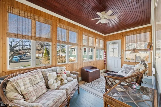 a kitchen with a refrigerator a sink and wooden floor