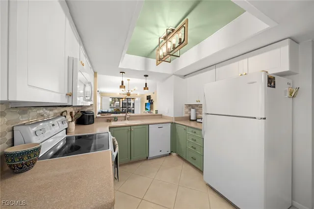 a kitchen with stainless steel appliances white cabinets and a refrigerator