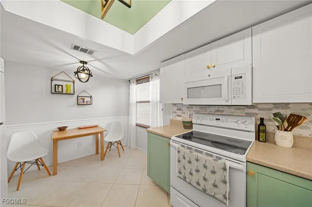 a kitchen with stainless steel appliances a stove a sink and a refrigerator