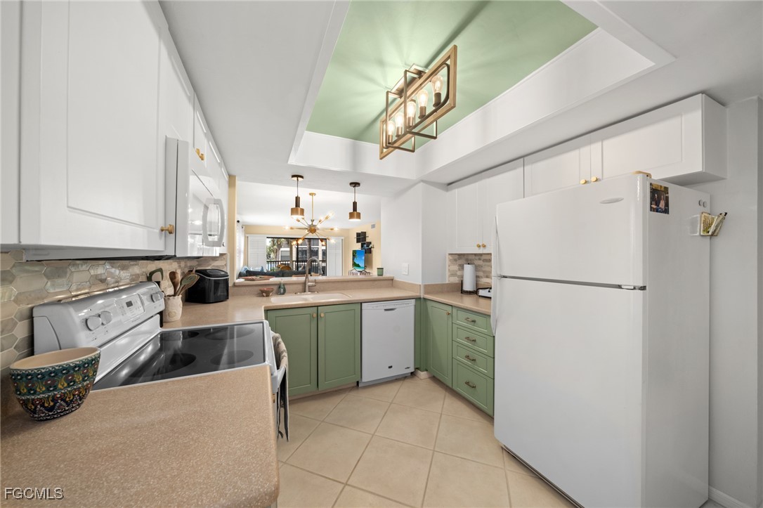 12581 Kelly Sands Way, Unit 518 Fort Myers, FL 33908 - Photo 13 of 33 a kitchen with stainless steel appliances white cabinets and a refrigerator