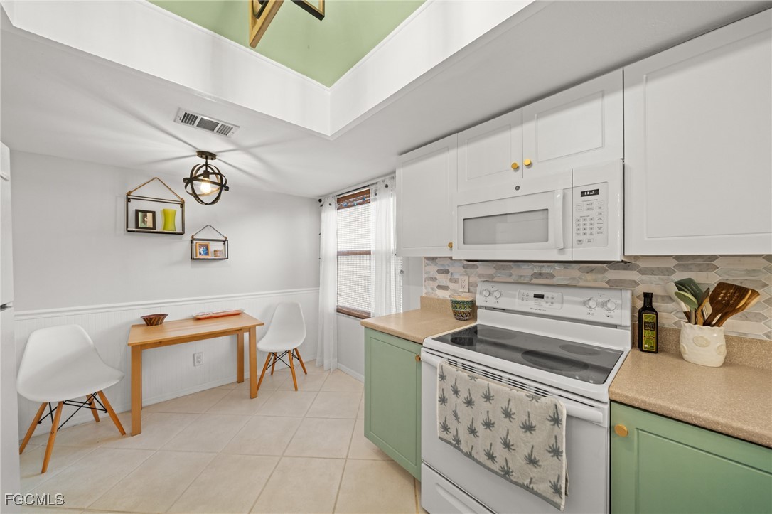 12581 Kelly Sands Way, Unit 518 Fort Myers, FL 33908 - Photo 14 of 33 a kitchen with stainless steel appliances a stove a sink and a refrigerator