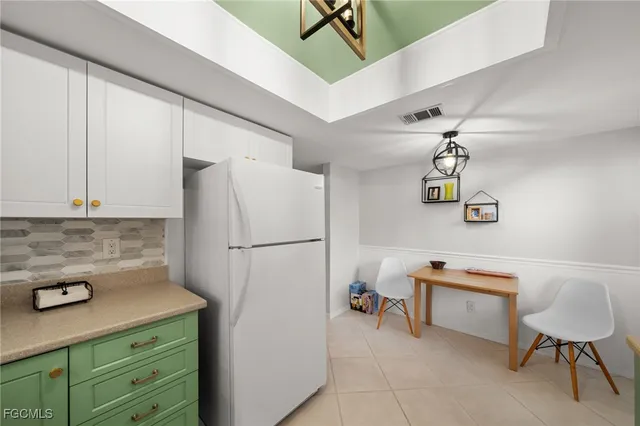 a kitchen with a refrigerator a stove a sink and a cabinets