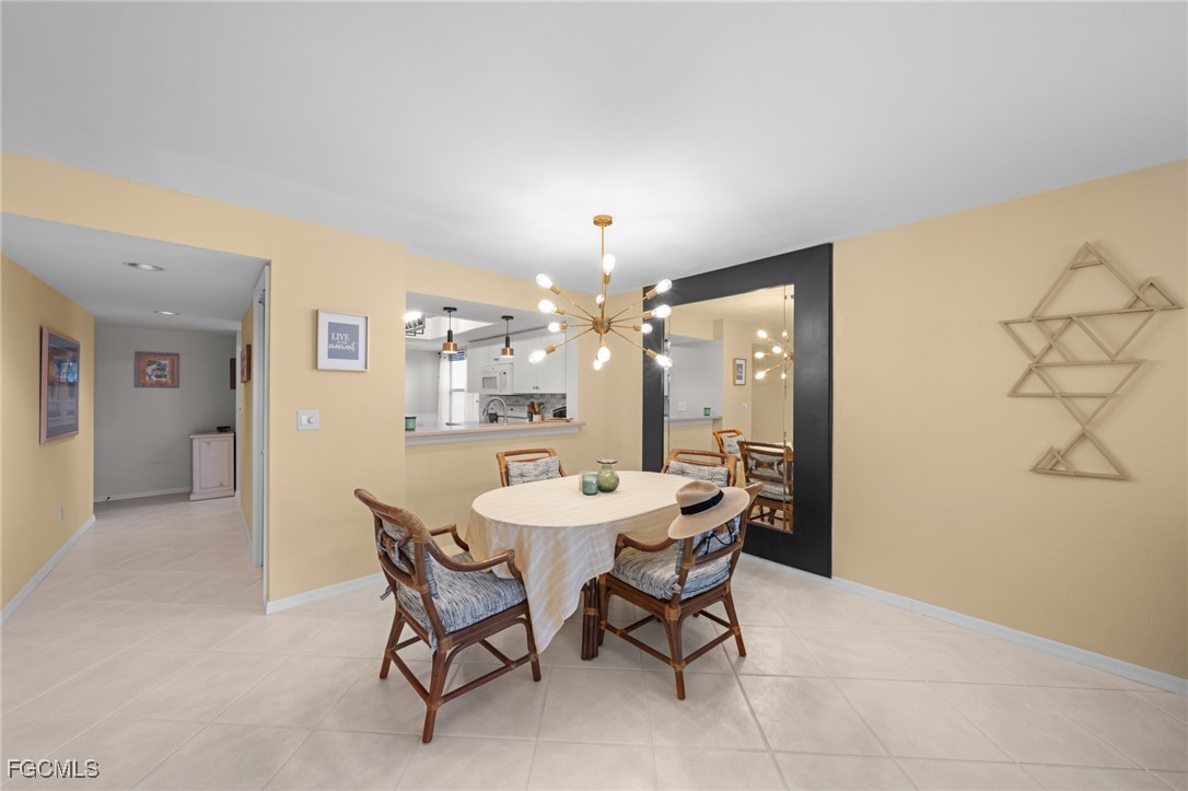 12581 Kelly Sands Way, Unit 518 Fort Myers, FL 33908 - Photo 17 of 33 a view of a dining room with furniture and chandelier