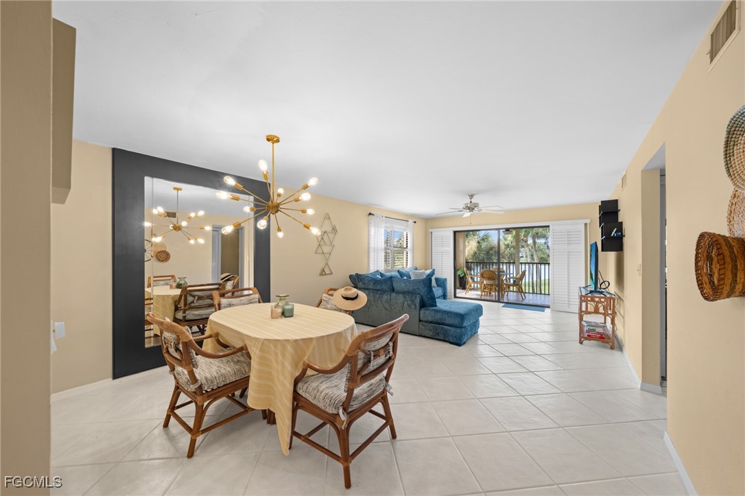 12581 Kelly Sands Way, Unit 518 Fort Myers, FL 33908 - Photo 18 of 33 a view of a dining room with furniture and chandelier