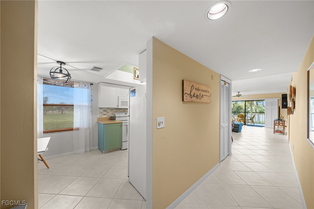 12581 Kelly Sands Way, Unit 518 Fort Myers, FL 33908 - Photo 19 of 33 a view of a kitchen cabinets and wooden floor