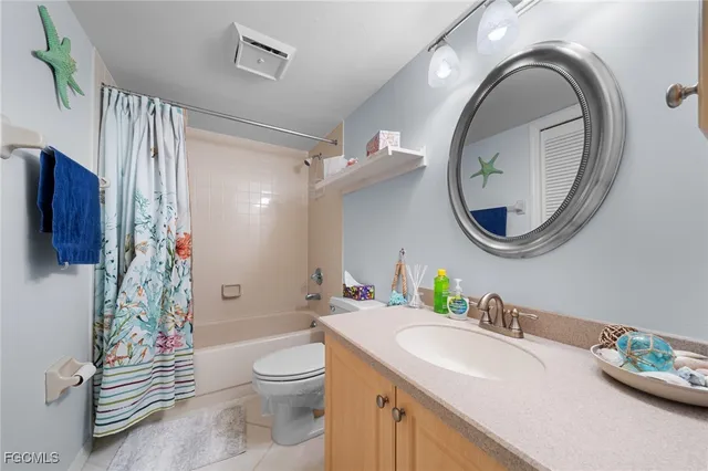 a bathroom with a toilet a sink and a mirror