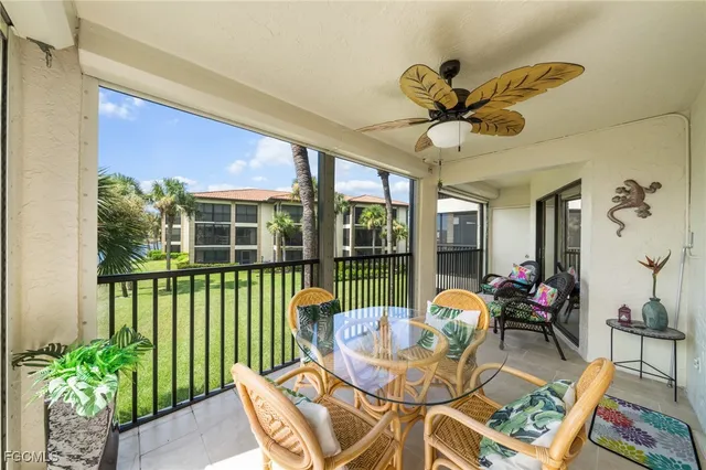 a dining room with furniture a potted plant and a chandelier