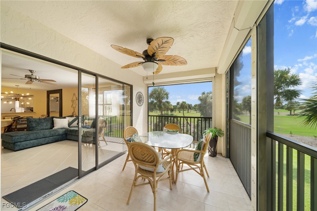 12581 Kelly Sands Way, Unit 518 Fort Myers, FL 33908 - Photo 28 of 33 a view of a porch with furniture and a yard