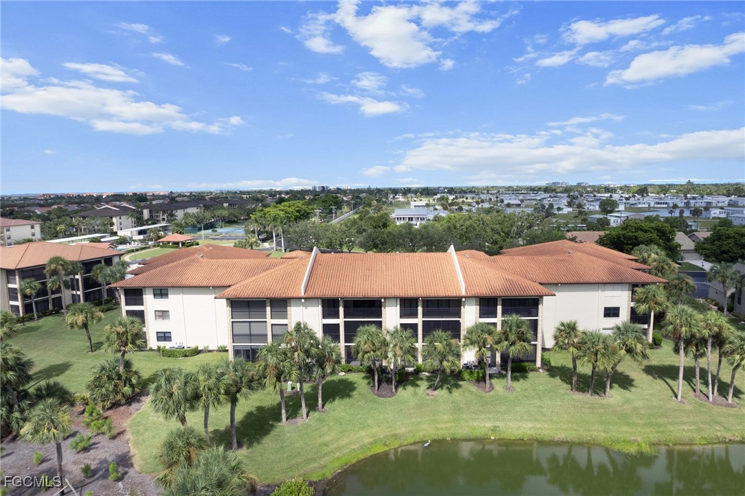 12581 Kelly Sands Way, Unit 518 Fort Myers, FL 33908 - Photo 29 of 33 a view of a house with yard and lake view