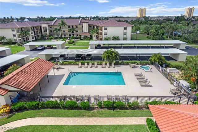 an aerial view of a house with a garden and lake view