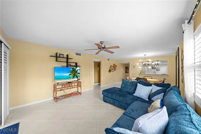 a living room with furniture flowerpot and a window