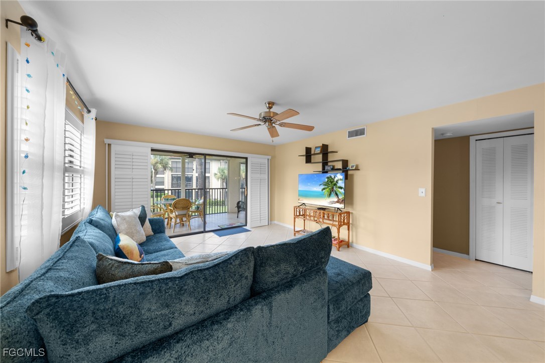 12581 Kelly Sands Way, Unit 518 Fort Myers, FL 33908 - Photo 10 of 33 a living room with furniture and a large window