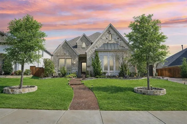 a front view of a house with a garden