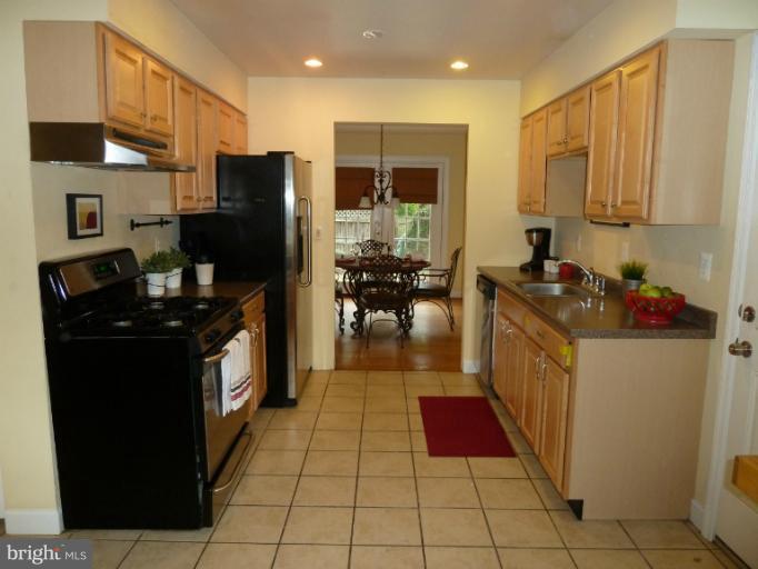 14424 Cantrell Road Silver Spring, MD 20905 - Photo 12 of 18 a kitchen with stainless steel appliances granite countertop a refrigerator and a stove