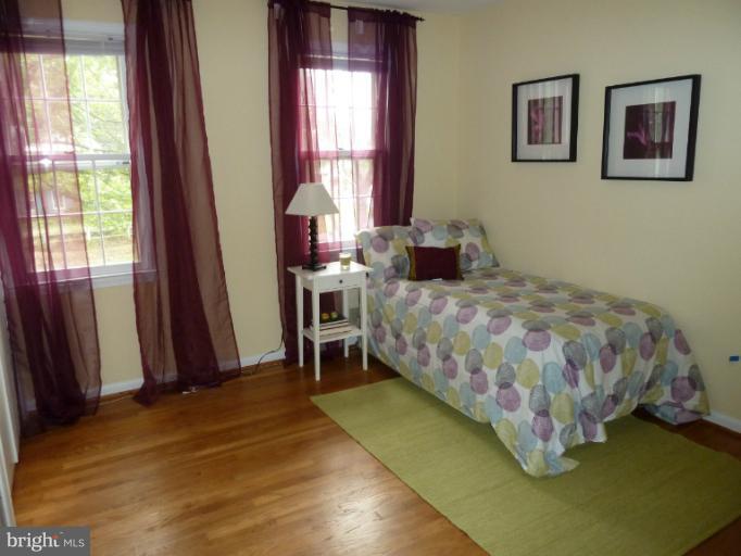 14424 Cantrell Road Silver Spring, MD 20905 - Photo 13 of 18 a bedroom with a bed and a window