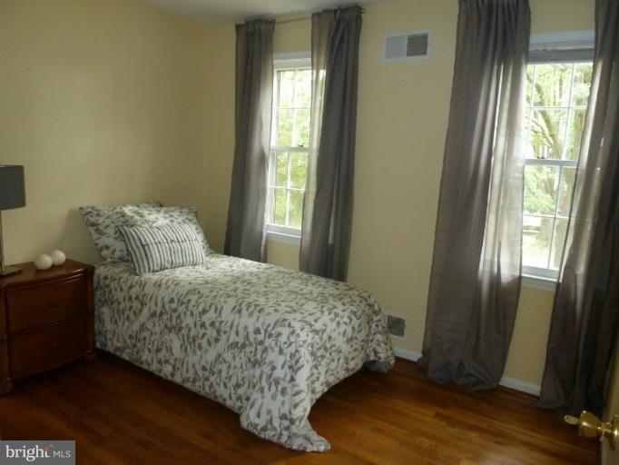 14424 Cantrell Road Silver Spring, MD 20905 - Photo 14 of 18 a living room with a bed furniture and a window