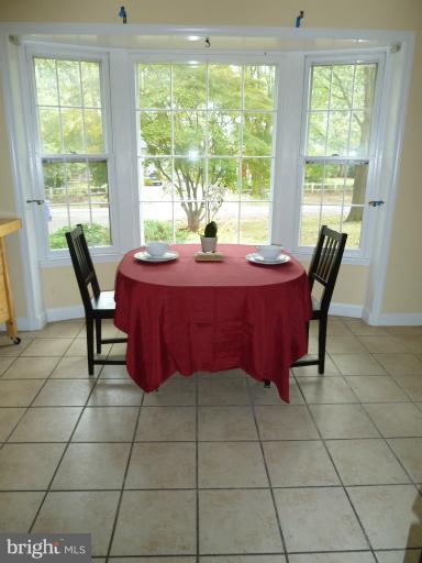 14424 Cantrell Road Silver Spring, MD 20905 - Photo 15 of 18 a dining table sitting in a room next to a window