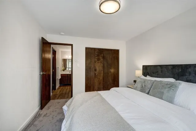 a bedroom with bed and window