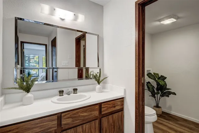 a bathroom with a toilet sink and mirror