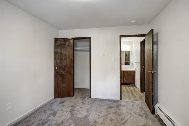 an empty room with closet and a bathroom