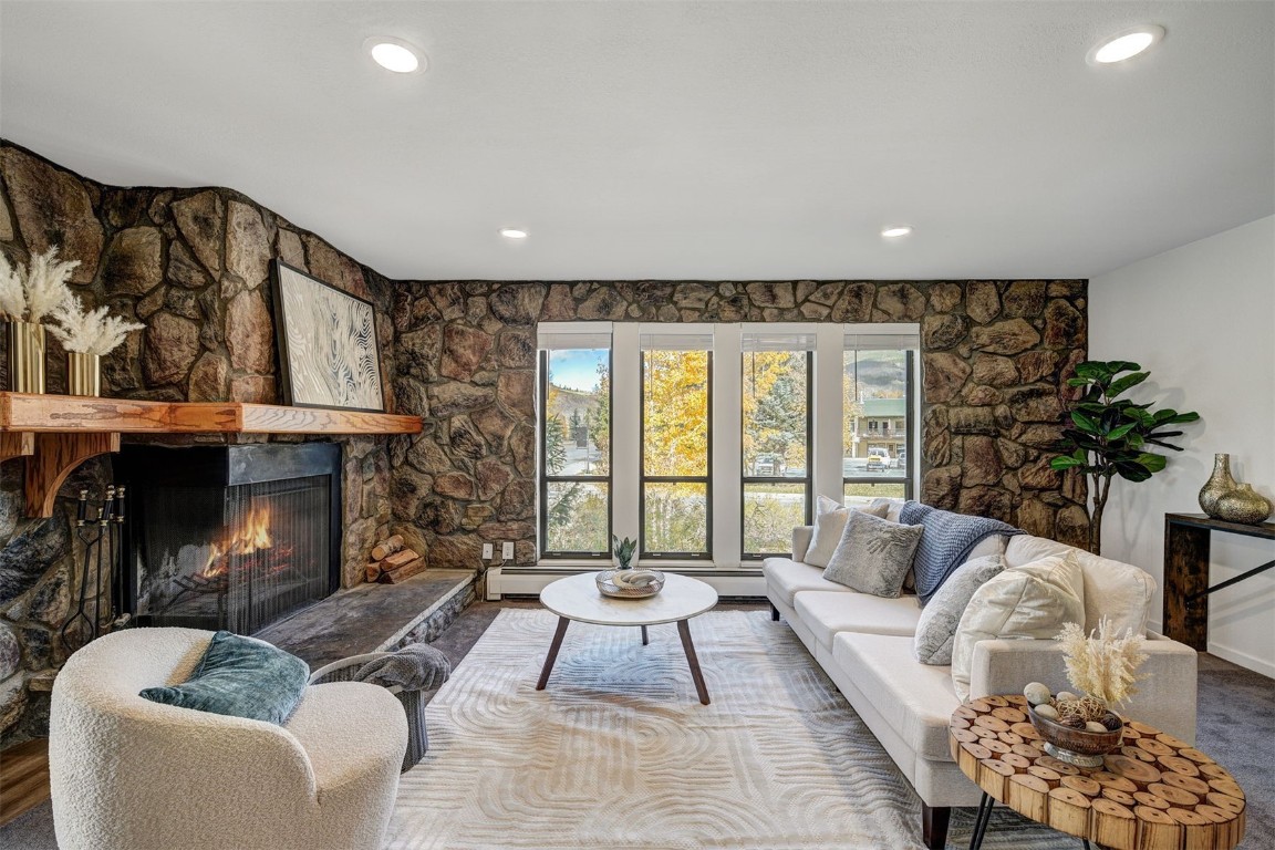 112 La Bonte Street, Unit 208 Dillon, CO 80435 - Photo 2 of 25 a living room with furniture and a fireplace