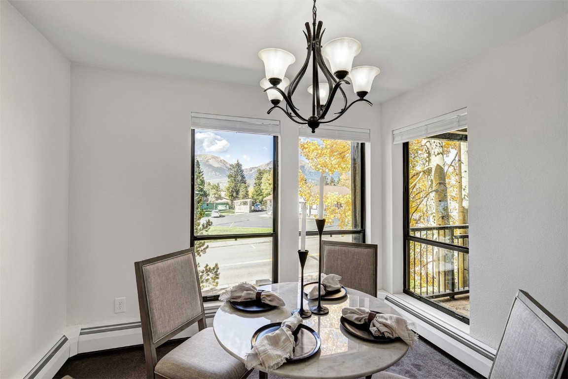 112 La Bonte Street, Unit 208 Dillon, CO 80435 - Photo 9 of 25 a view of a dining room with furniture wooden floor and chandelier