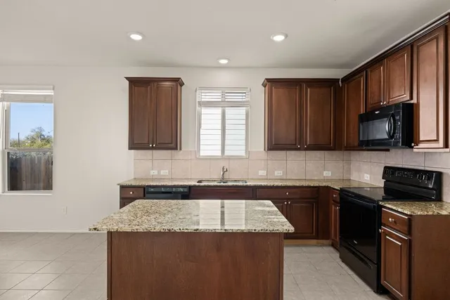 a kitchen that has a sink and a stove in it