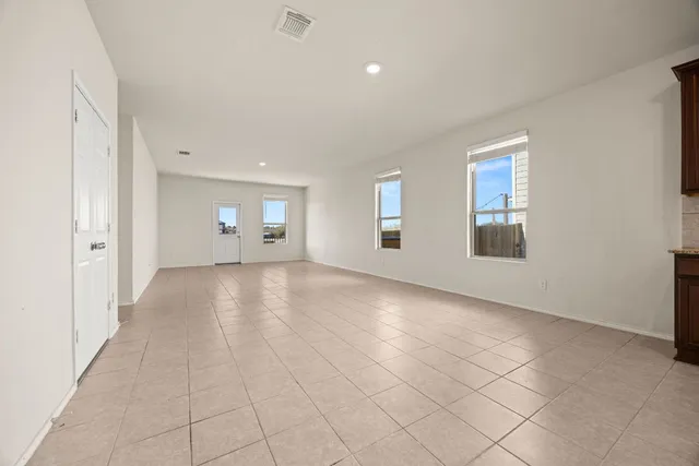 a view of empty room with window and fireplace