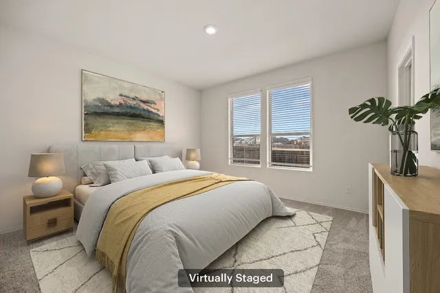 a bedroom with a bed and a painting on the wall